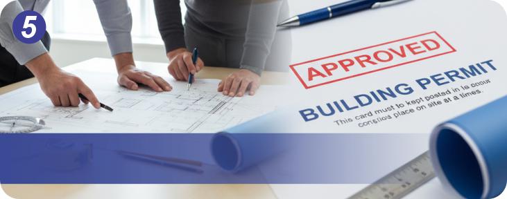 Team reviewing approved building permit plans and renderings for municipal project submission.