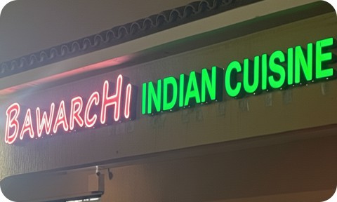 Channel letters sign for a business in a shopping center at night