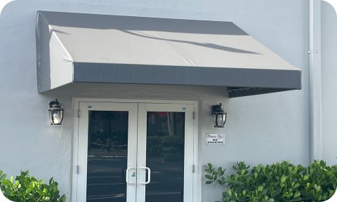 Rectangular canvas awning above double glass commercial door