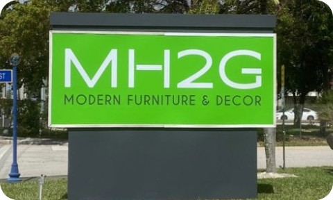 Modern commercial monument sign with bold green panel and white text