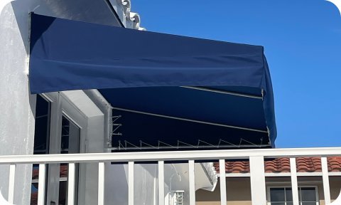 Residential awning above balcony door providing shade and protection