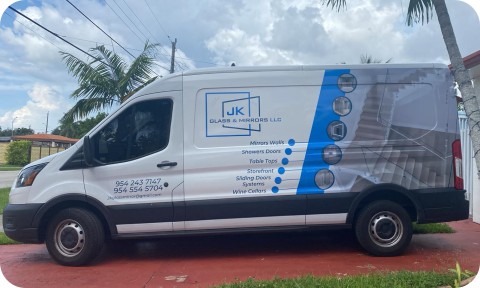 Custom vinyl wrap on a work van with logo and service details
